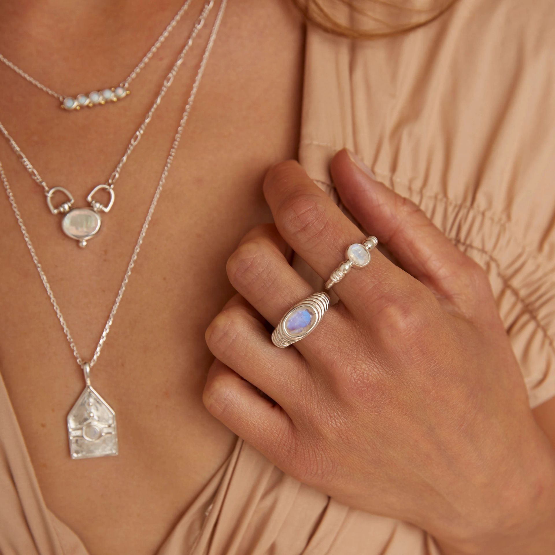 a Woman's Hand With Three Bracelets and a Ring on It — Montaze In Erina, NSW