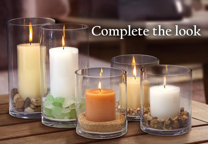 A group of candles in glass containers on a table with the words complete the look above them.