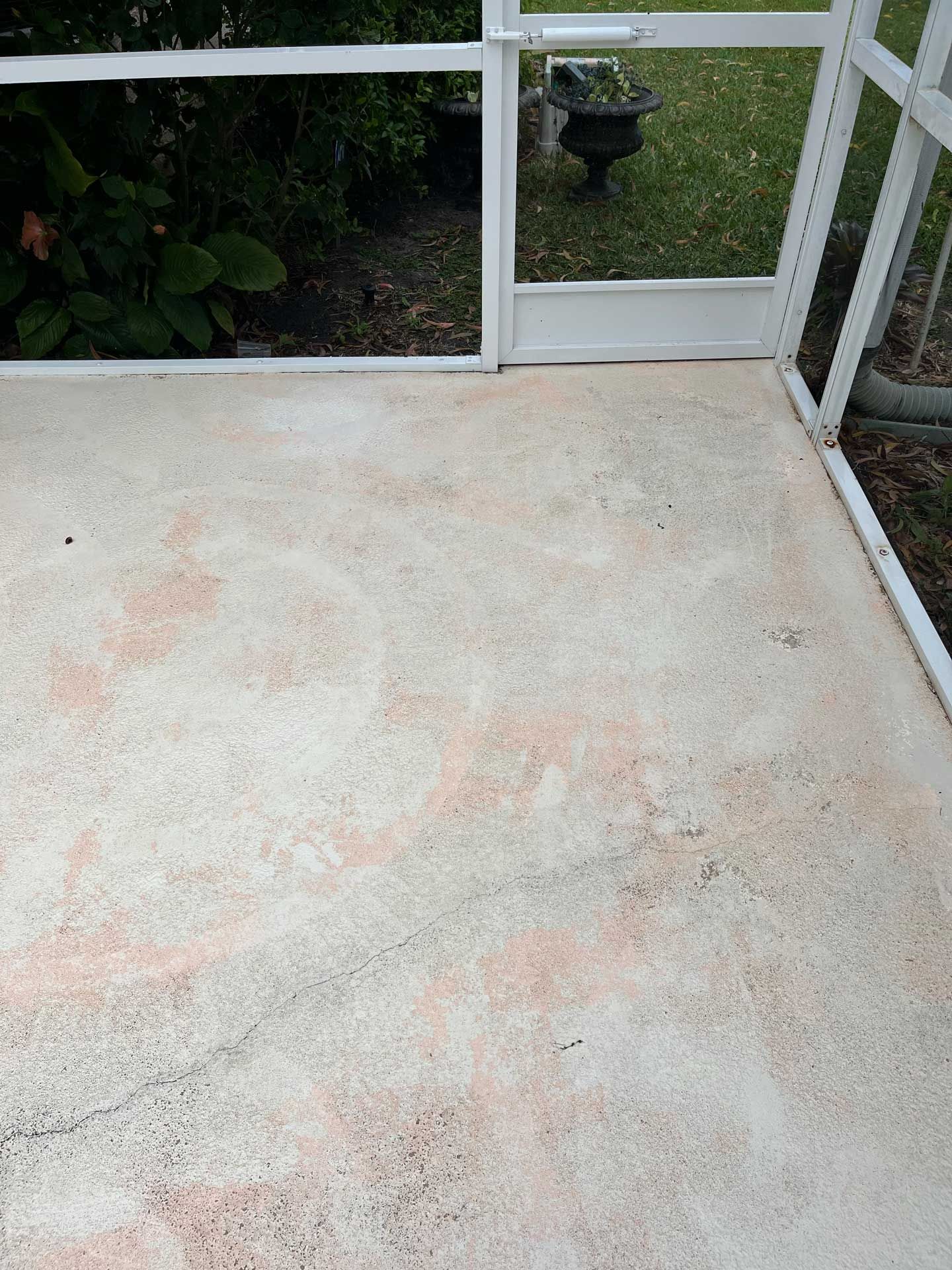A patio with a white railing and a white fence.