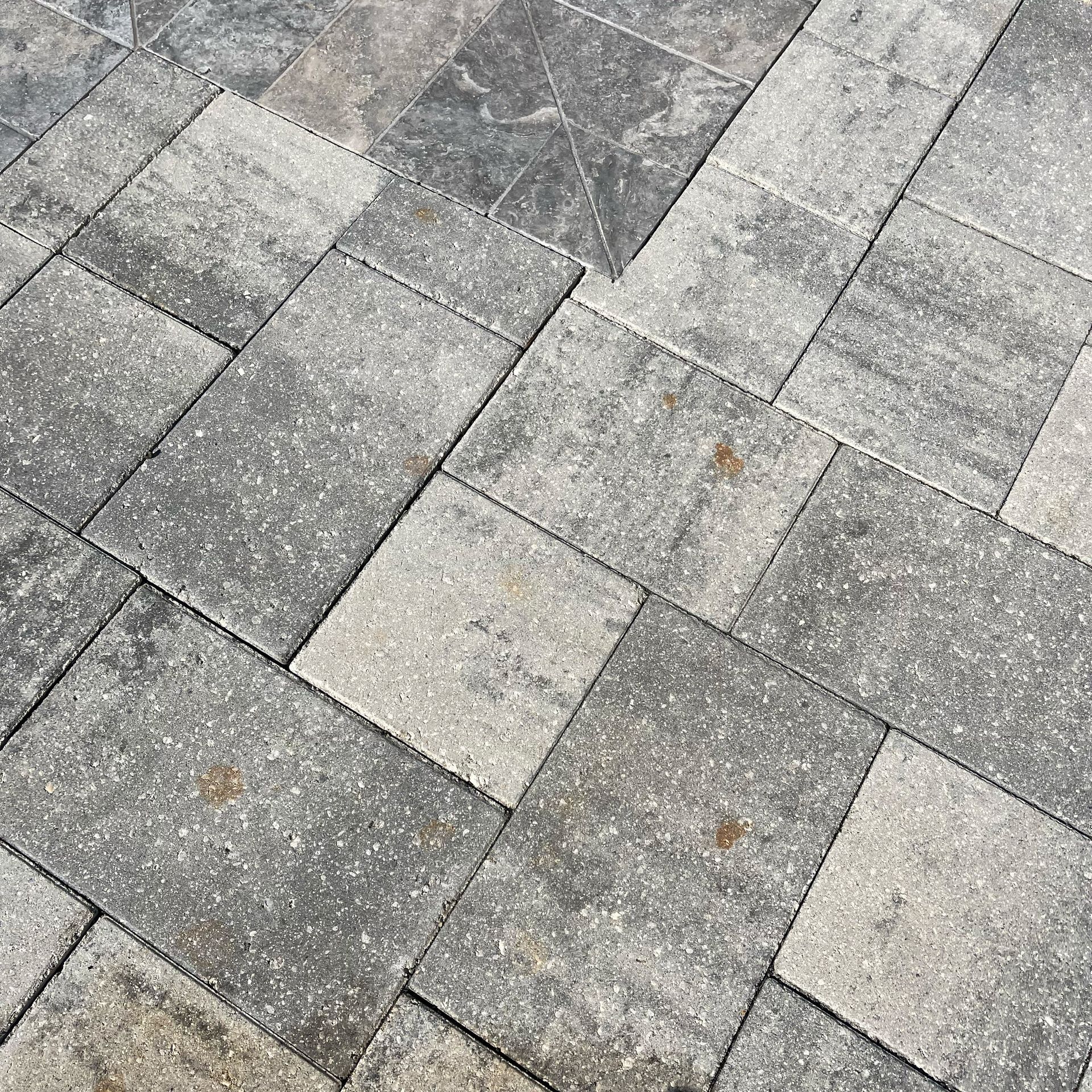 A close up of a brick pavement with a diagonal pattern.