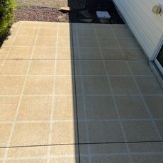 A tiled walkway leading to a white house