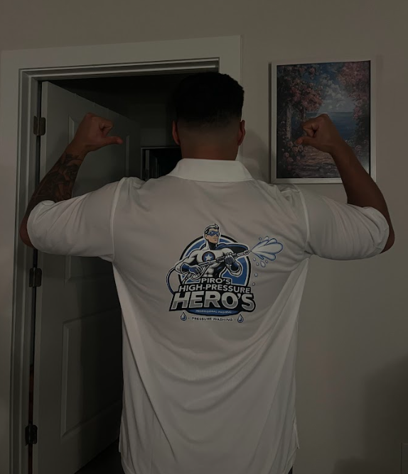 A man wearing a white shirt with the word heros on it