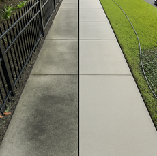 A tiled walkway leading to a white house