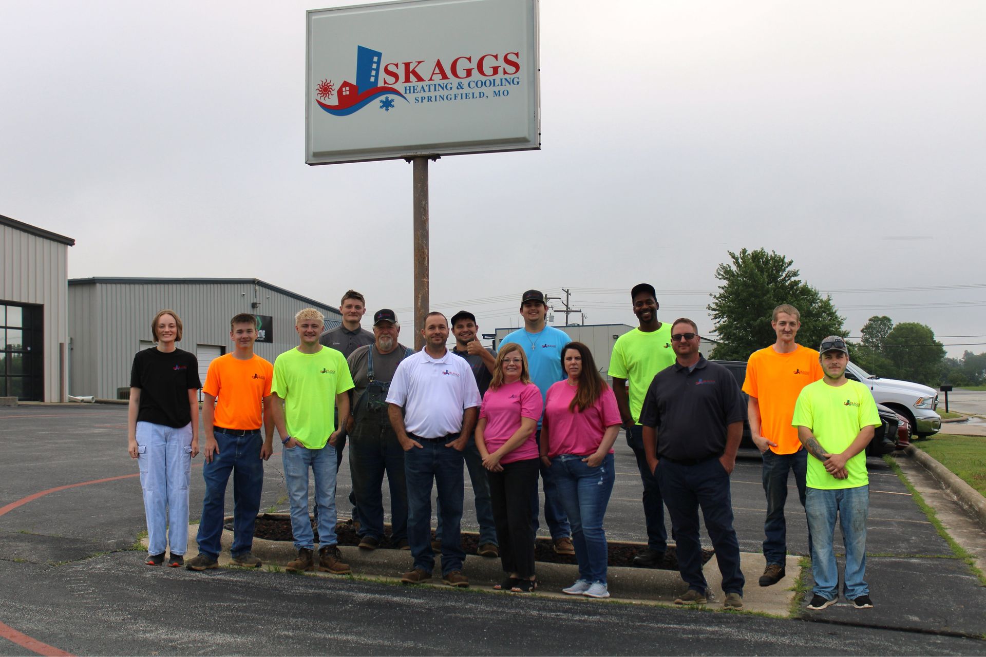 A group of people standing in front of a sign that says skaggs