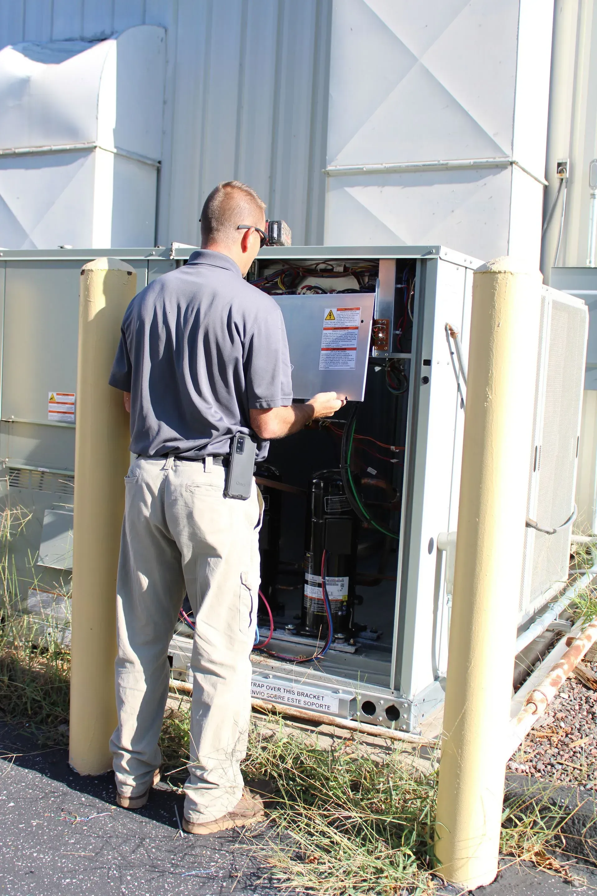 A man is standing in front of a box that says ' electrical ' on it