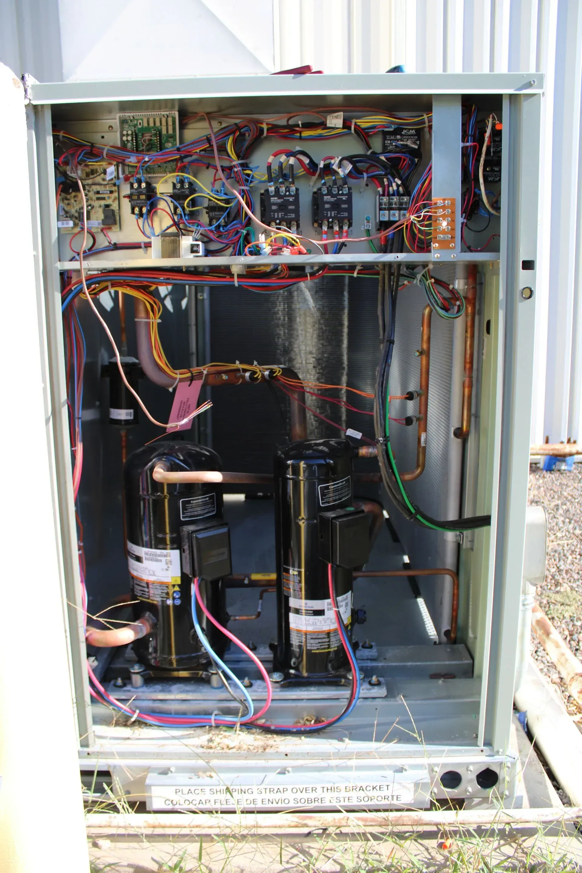 The inside of a box with a lot of wires coming out of it.