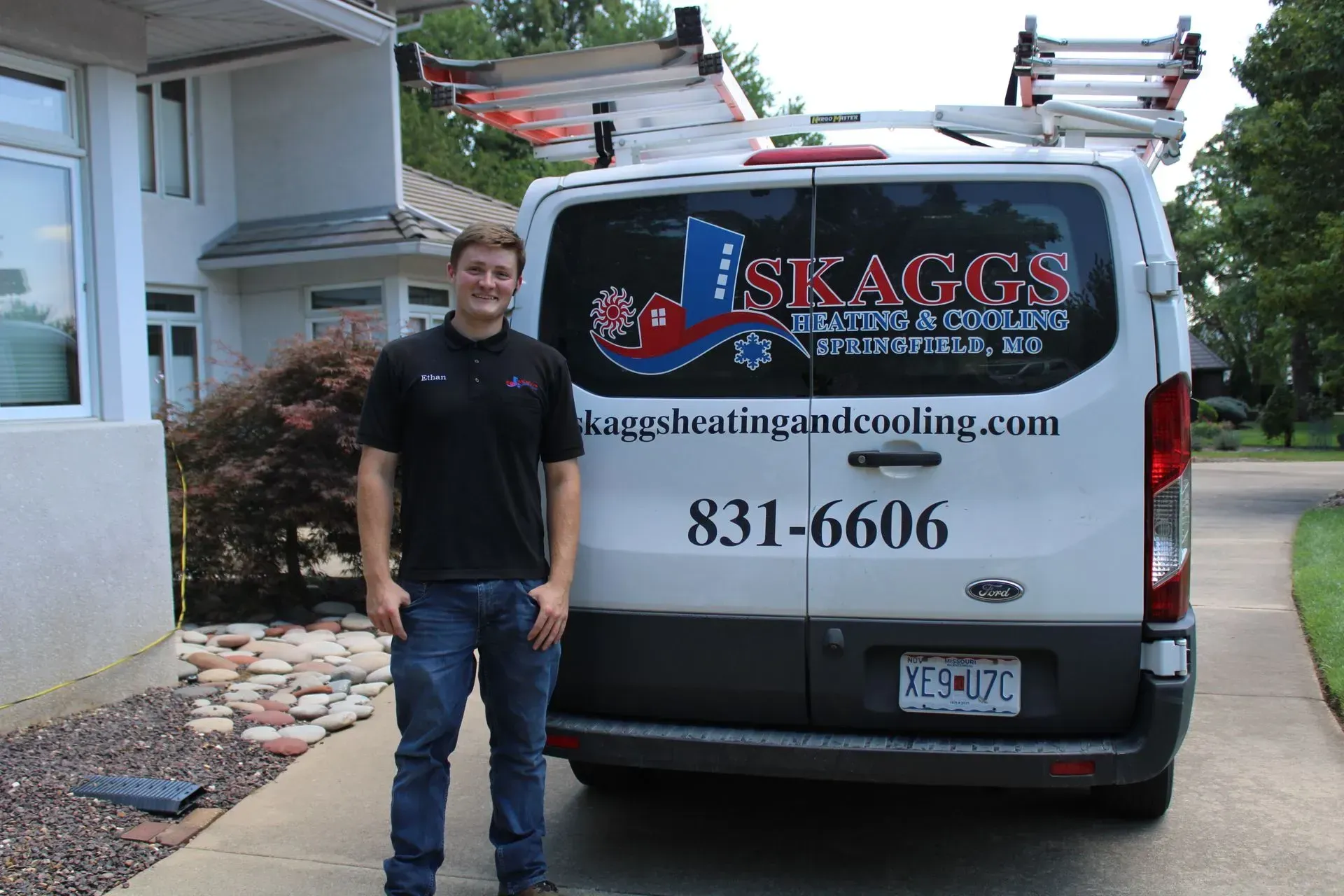 A man standing in front of a skaggs van