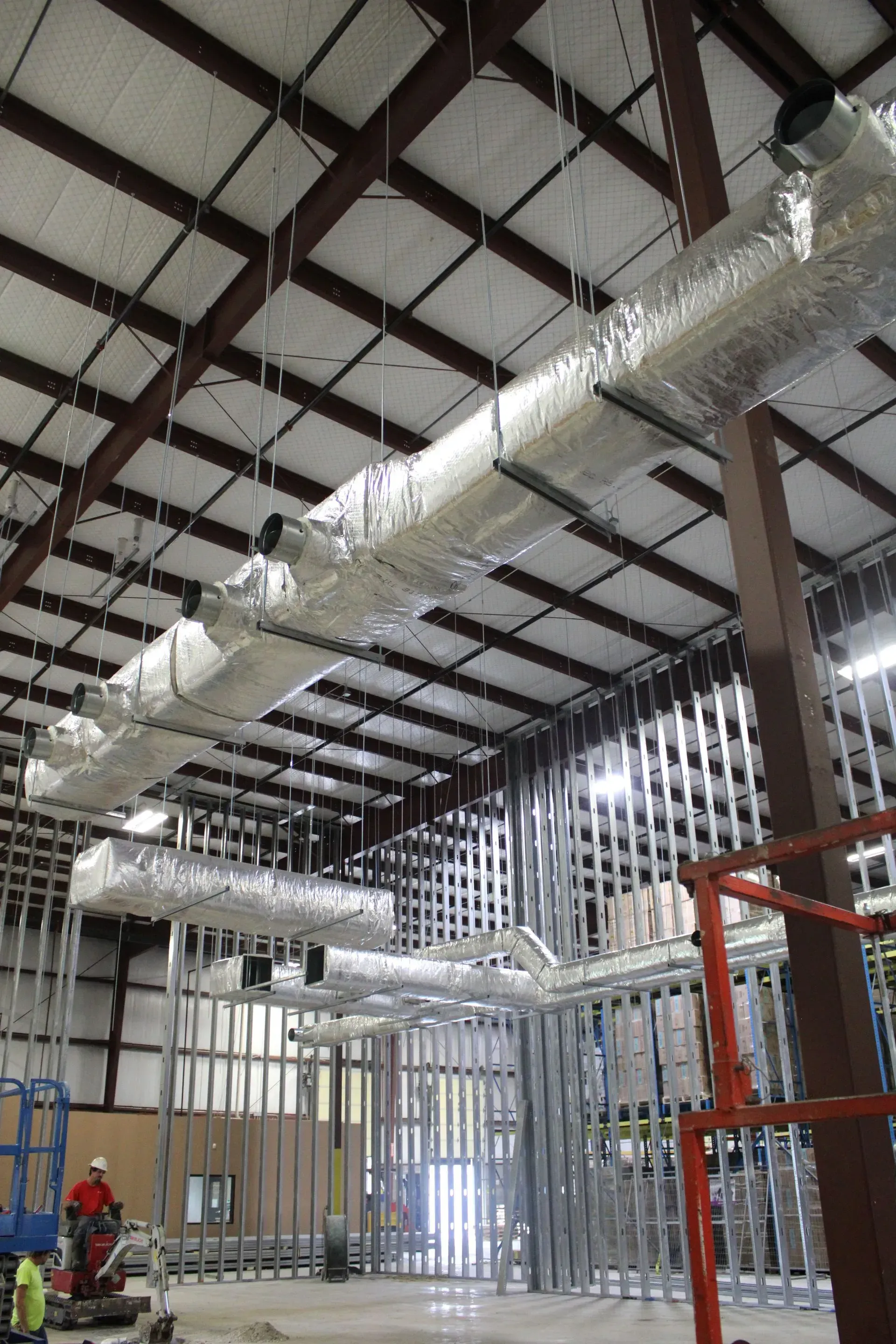 A large room with a lot of pipes hanging from the ceiling