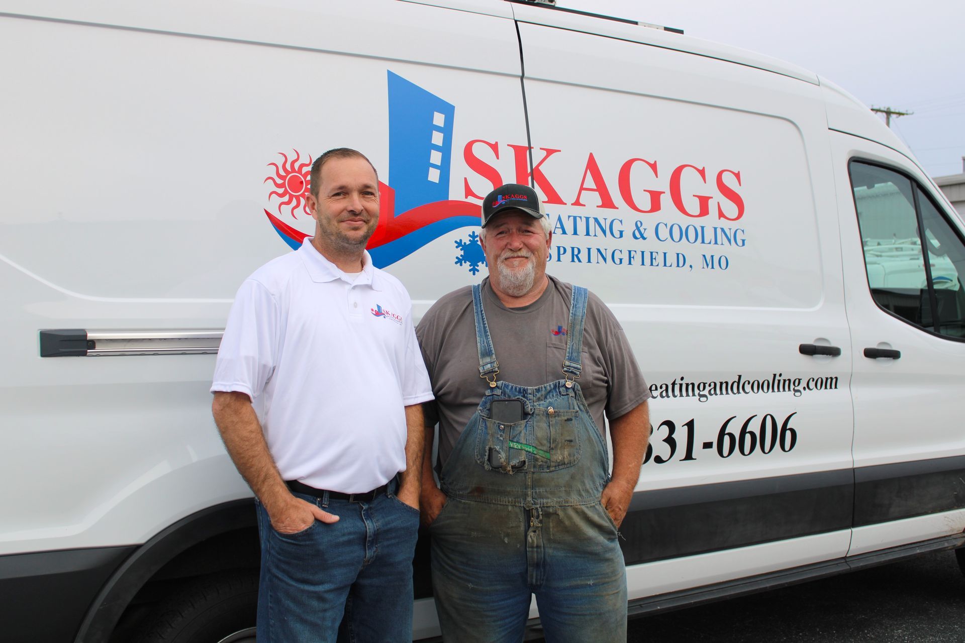 Two men are standing in front of a skaggs van