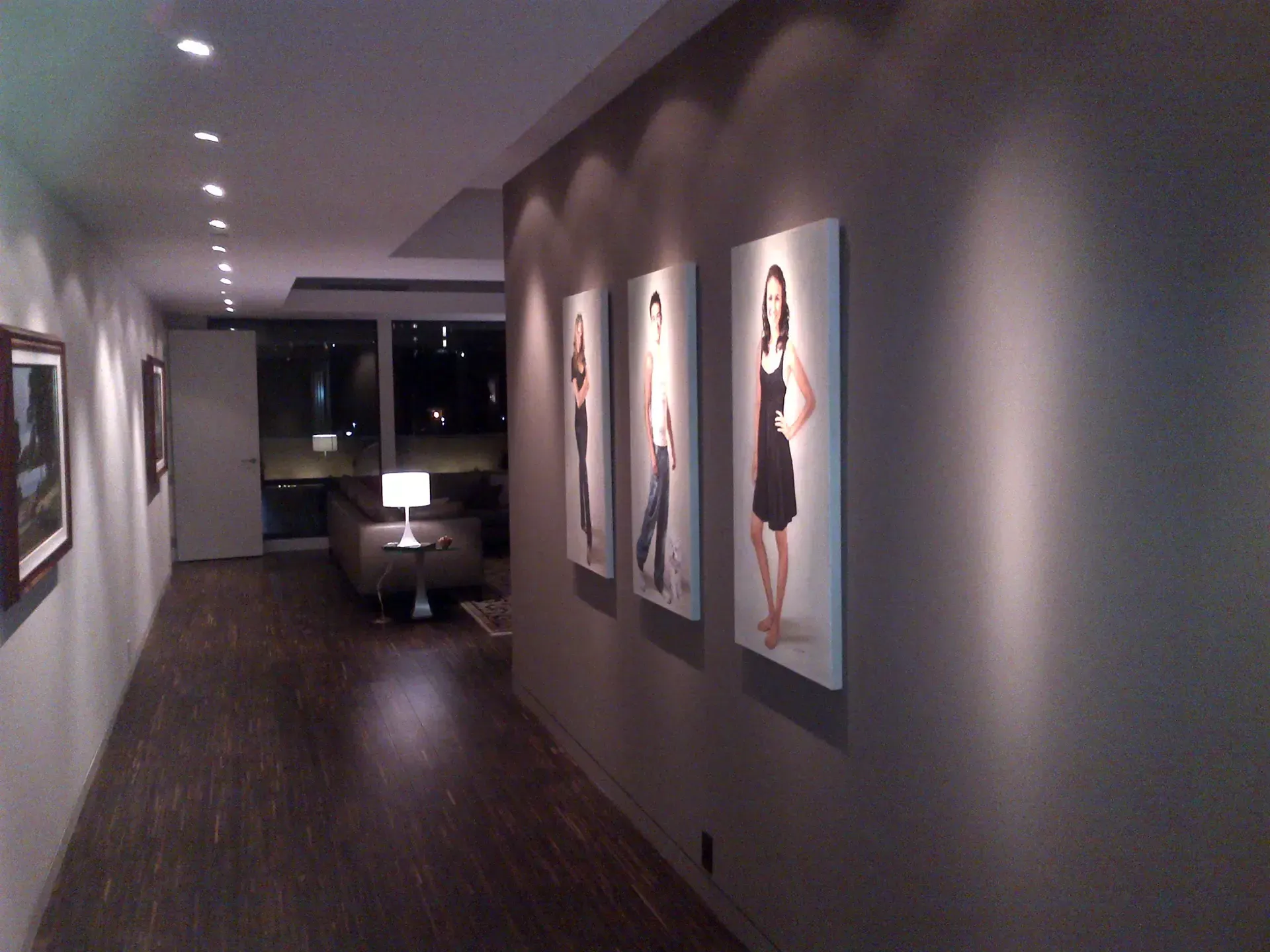 A hallway with paintings of women on the wall