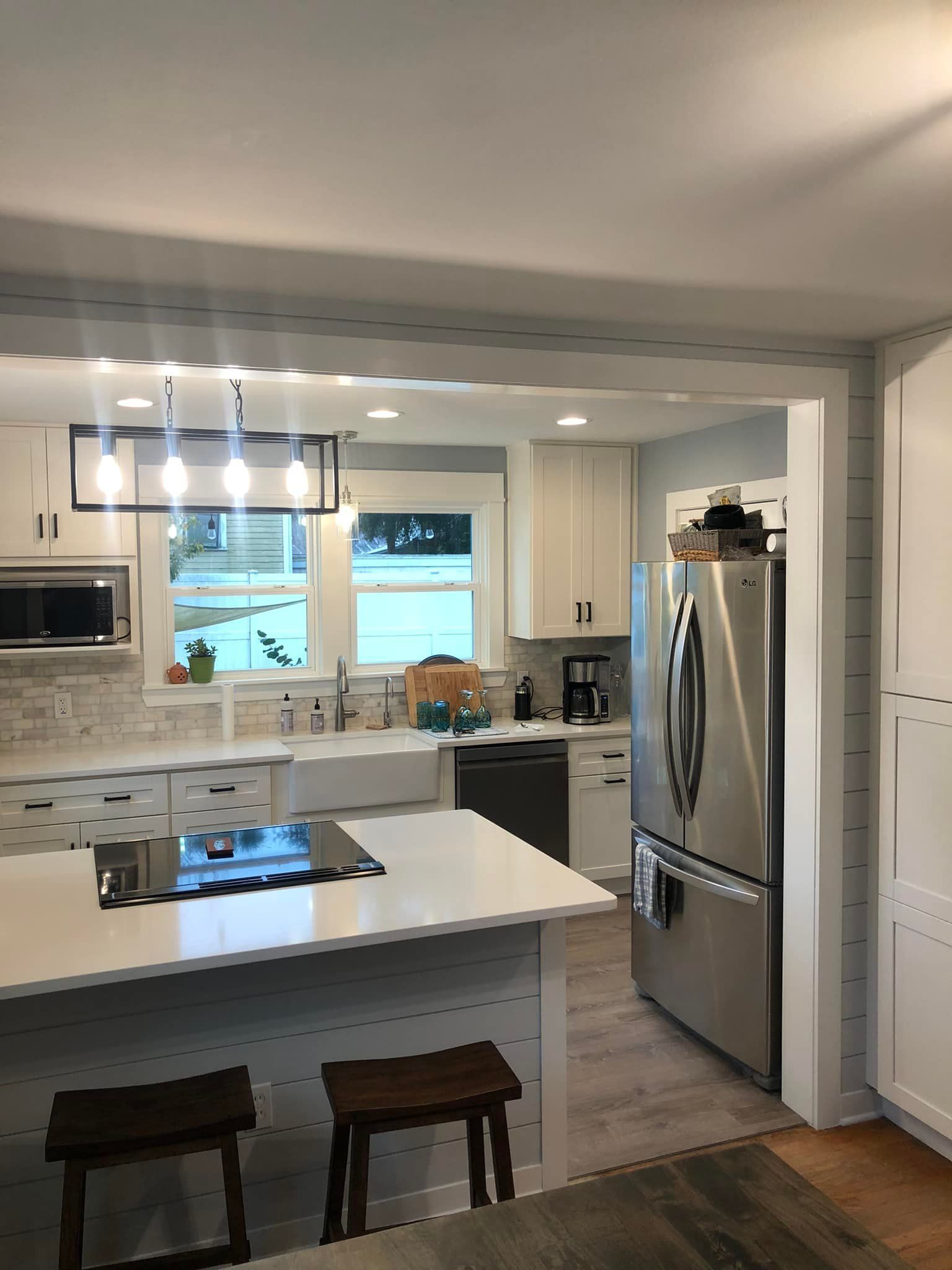 A kitchen with stainless steel appliances and white cabinets
