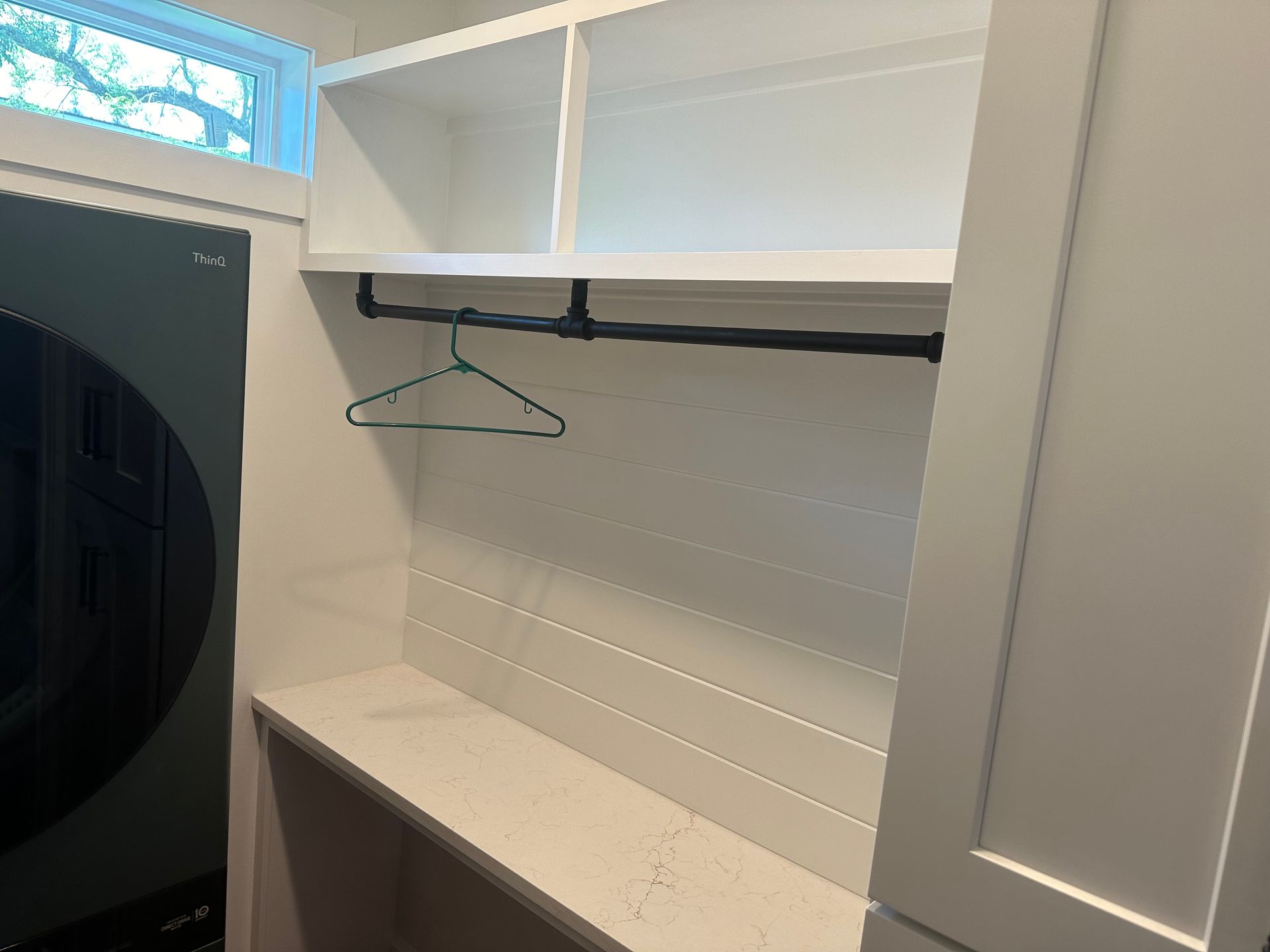 A wooden table with a model of a house on it.