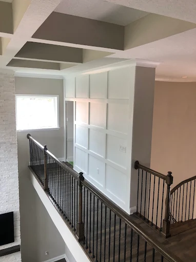 A view of a custom staircase from the second floor of a house.