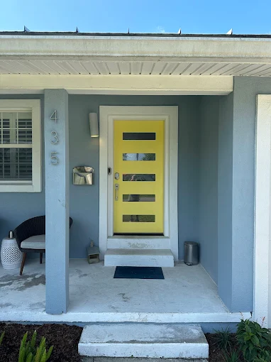 A room with a white wall and a desk in it.