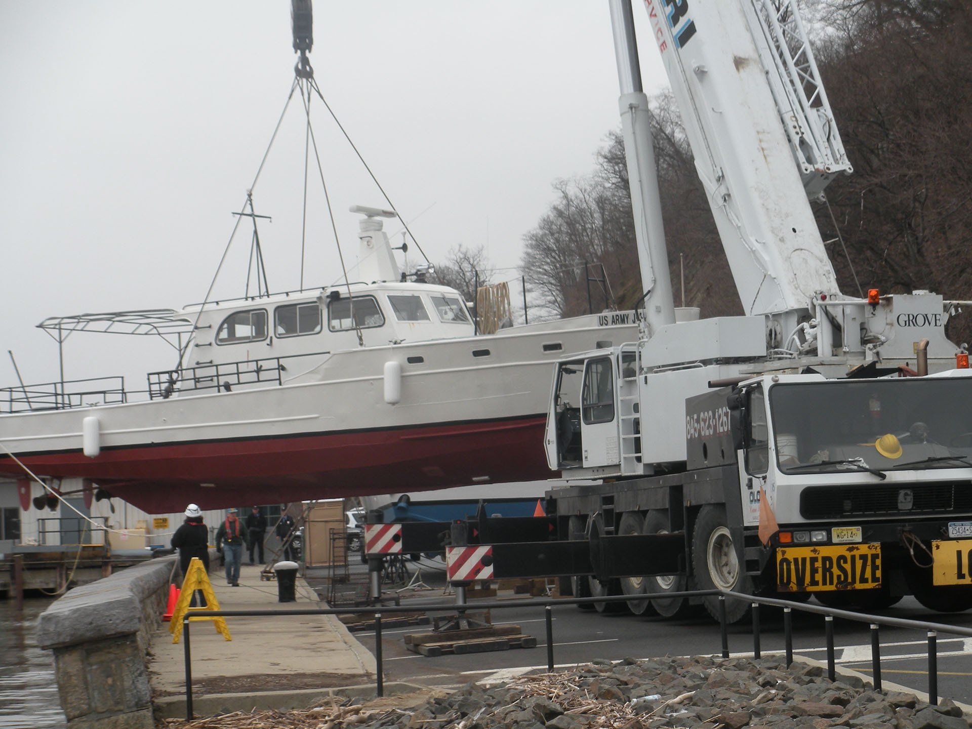 Lifting a Red and White Boat — Nanuet, NY — Olori Crane Service, Inc.