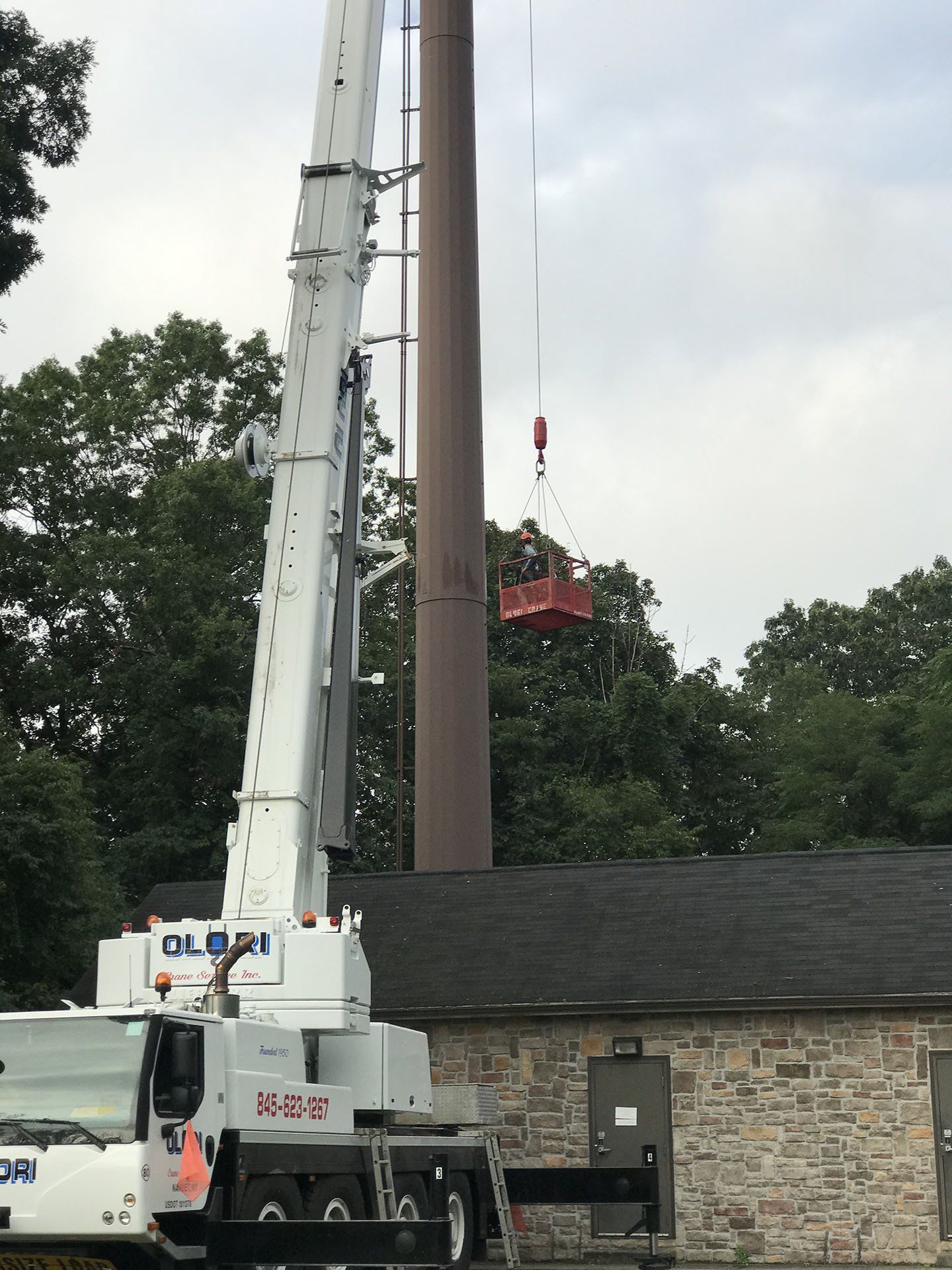 Man on Bucket Crane — Nanuet, NY — Olori Crane Service, Inc.