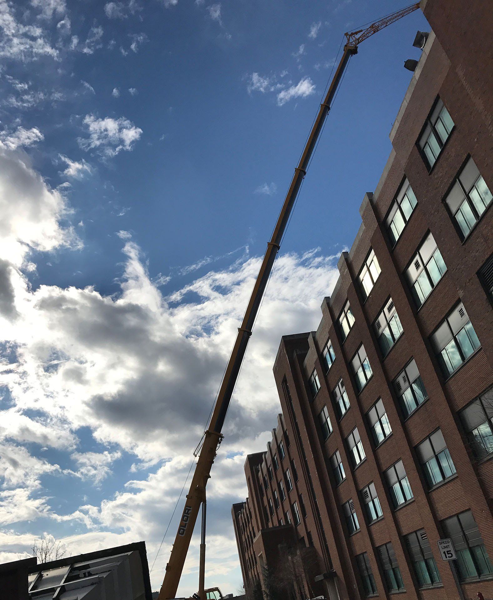 Crane Lifting Materials on Building Roof — Nanuet, NY — Olori Crane Service, Inc.