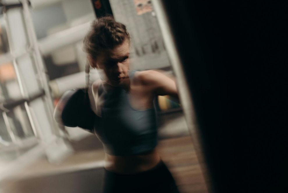 Athlete training in a moody, low-lit studio