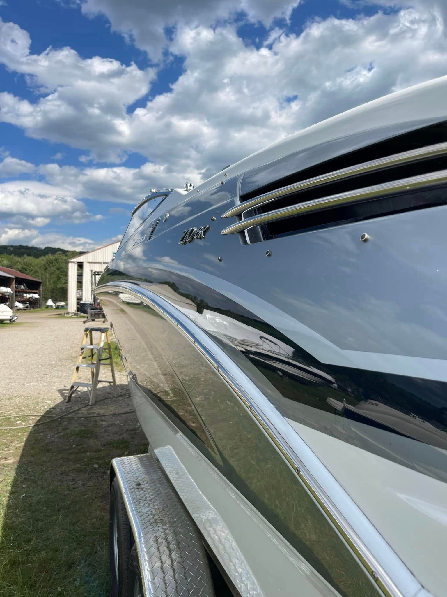 A boat is parked on a trailer in a parking lot.