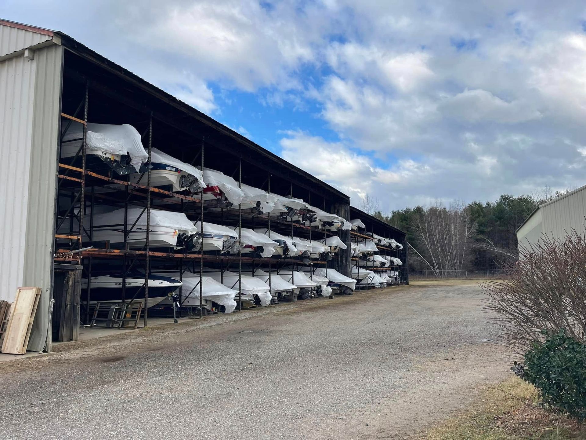 A row of boats are lined up in a warehouse.