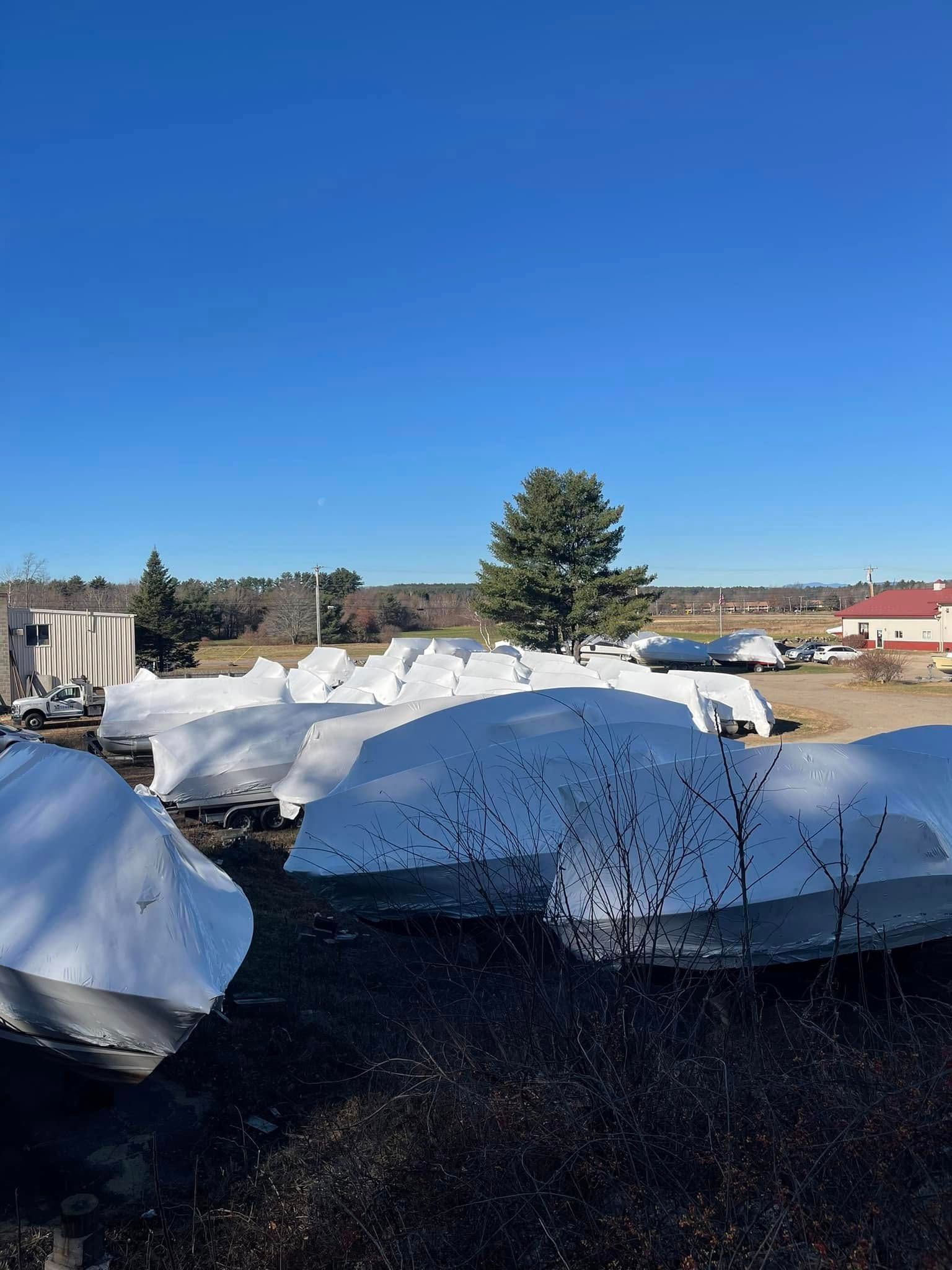 A large pile of snow is sitting in the middle of a field.