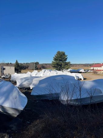 A large pile of snow is sitting in the middle of a field.