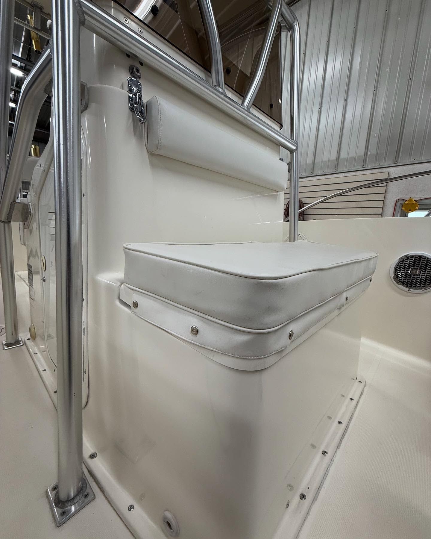 A white boat with a white seat and railing