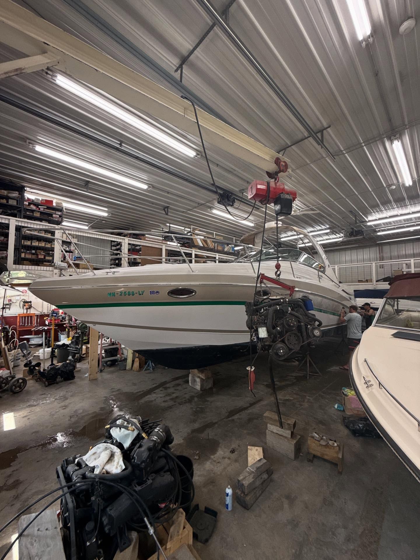A boat is being worked on in a garage.