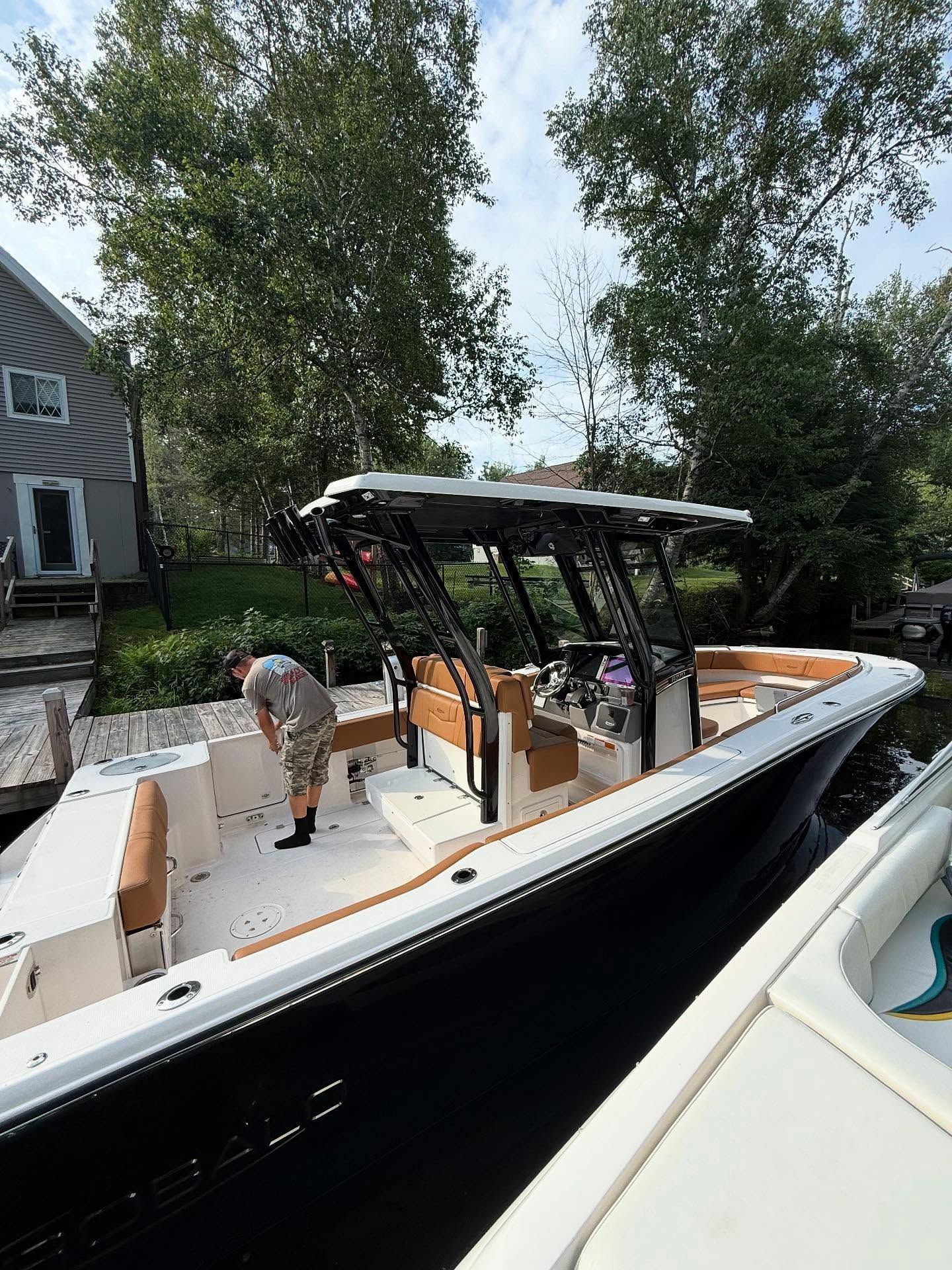 A man is standing on the deck of a boat.