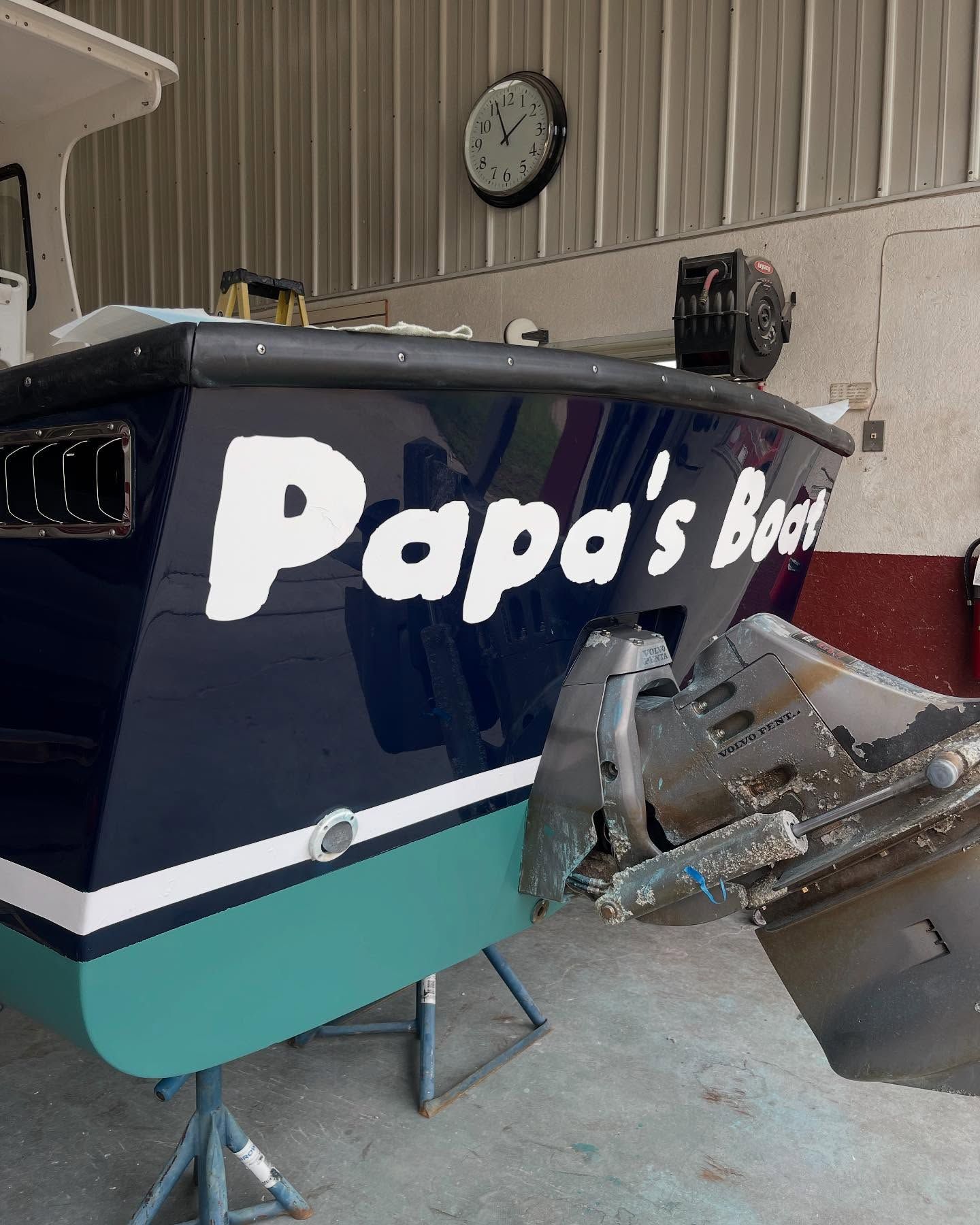 A blue boat with papa 's boat written on it
