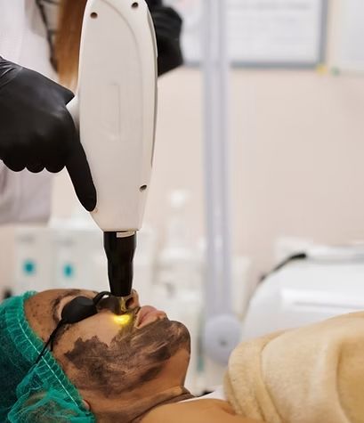 A woman is getting a laser treatment on her face.