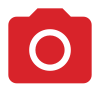 Une caméra rouge avec un cercle blanc au milieu.