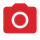 Une caméra rouge avec un cercle blanc au milieu.