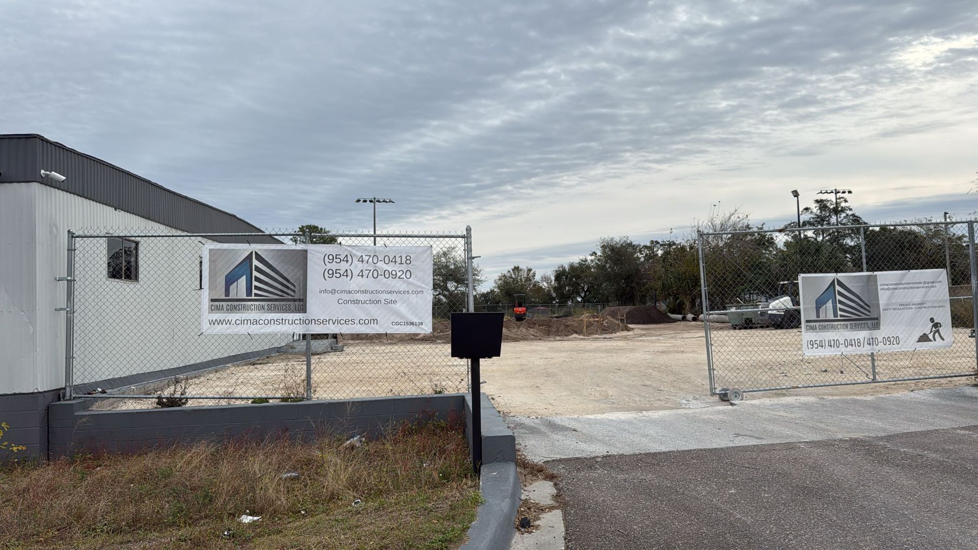 A construction site with a fence and signs on it.