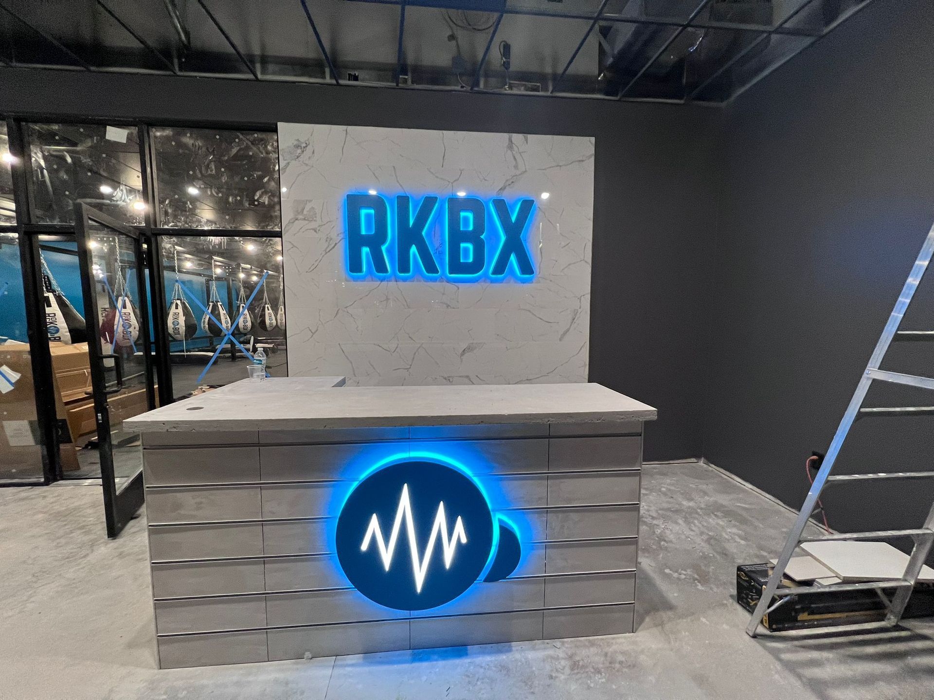 A reception desk with a sign that says rkbx on it.