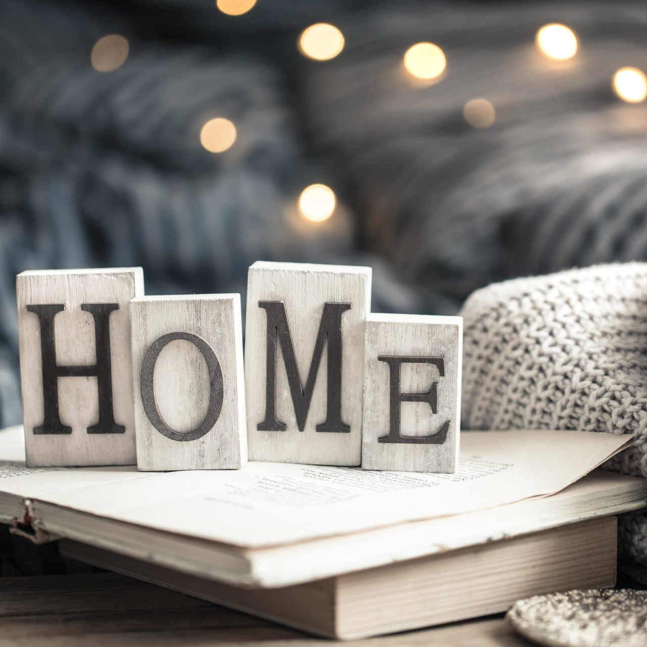 The word home is written on wooden blocks on top of a book