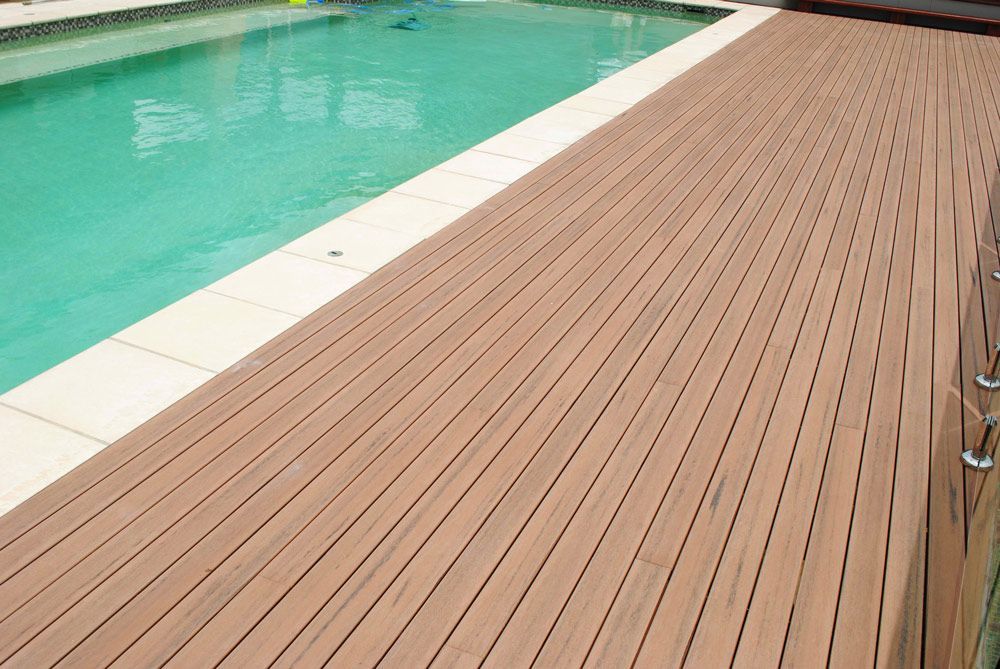 A Wooden Deck Next to a Swimming Pool — B & B Timbers Ballina In West Ballina, NSW