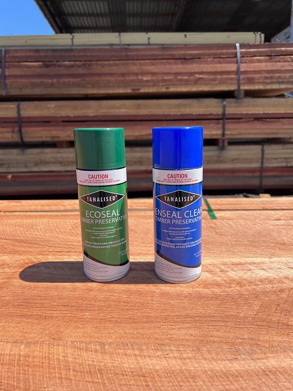 Two Cans of Spray Paint Are Sitting on a Wooden Table — B & B Timbers Ballina In West Ballina, NSW