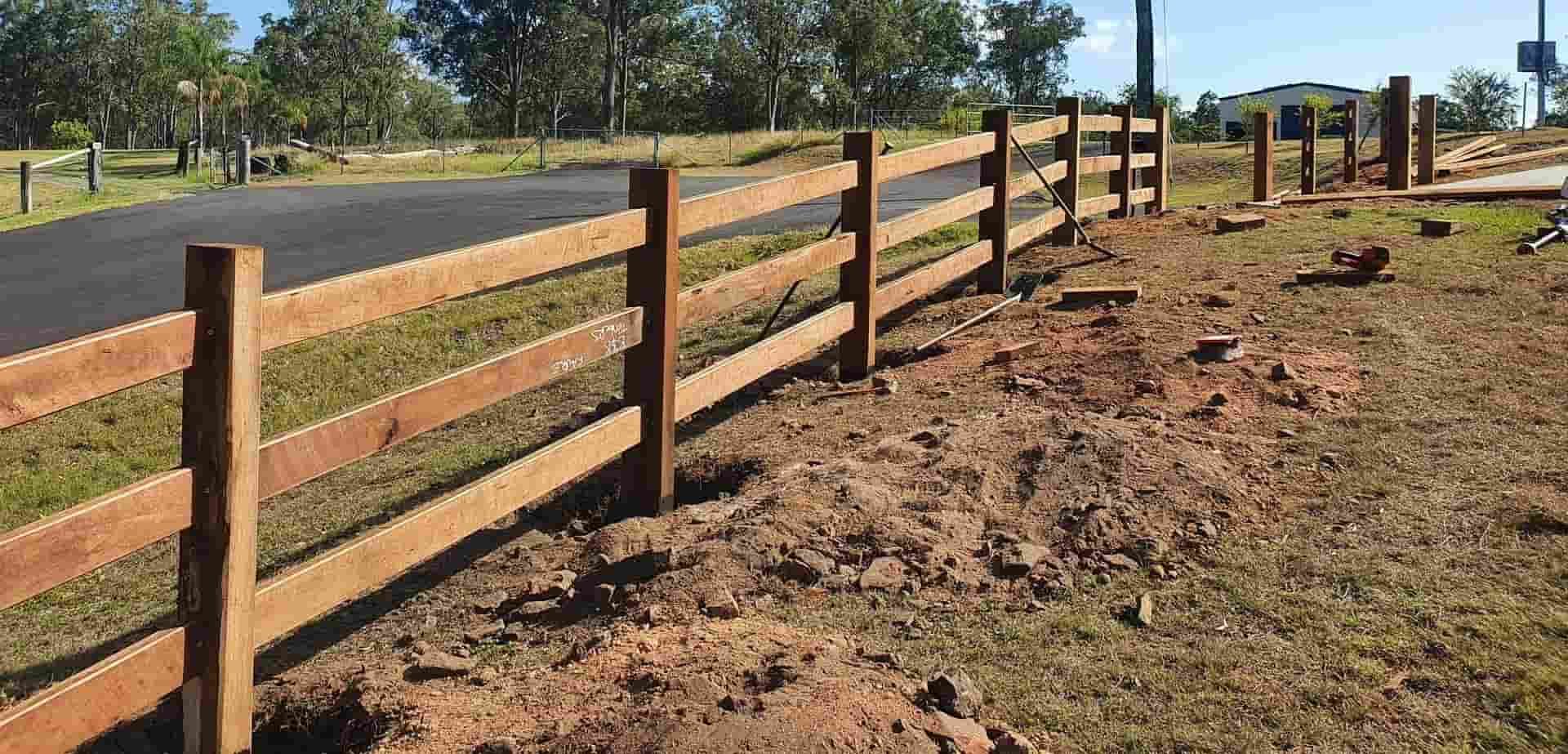 A Wooden Fence is Being Built Next to a Road — B & B Timbers Ballina In West Ballina, NSW