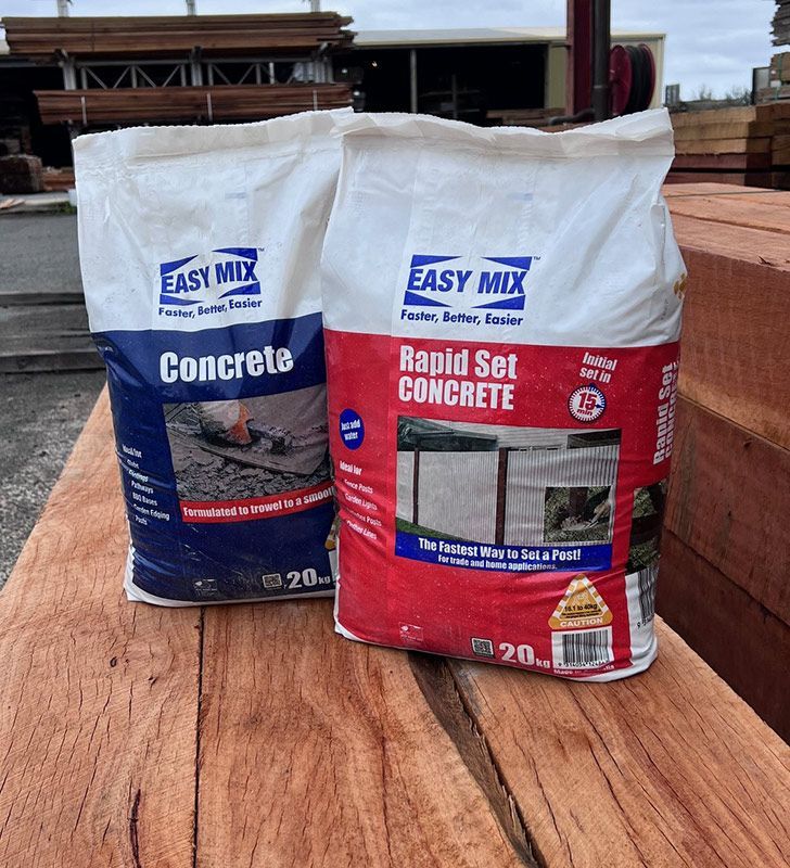 Two Bags of Easy Mix Concrete and Rapid Set Concrete on a Wooden Table — B & B Timbers Ballina In West Ballina, NSW