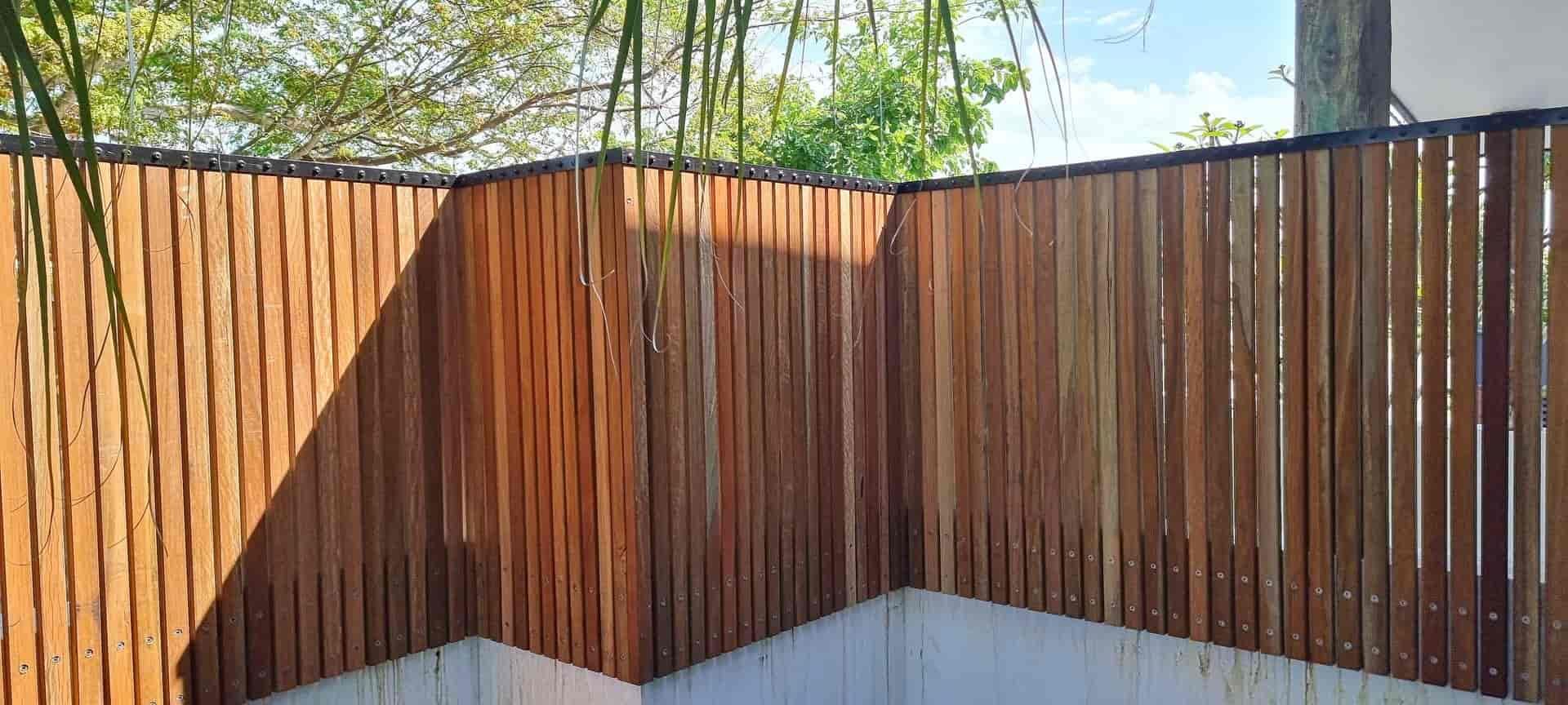 A Wooden Fence is Surrounding a Pool in a Backyard — B & B Timbers Ballina In West Ballina, NSW
