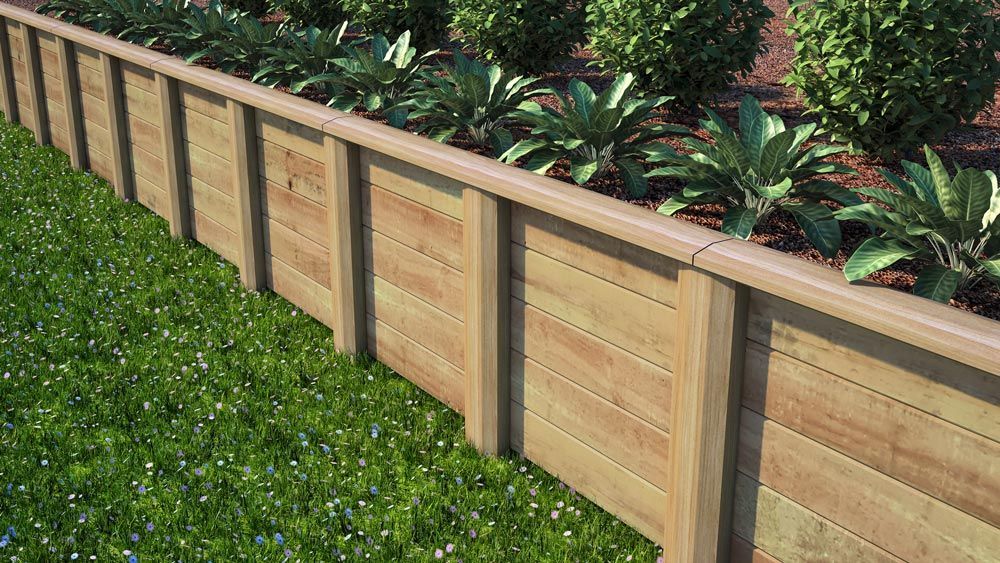 A Wooden Fence is Surrounded by Plants in a Garden — B & B Timbers Ballina In West Ballina, NSW