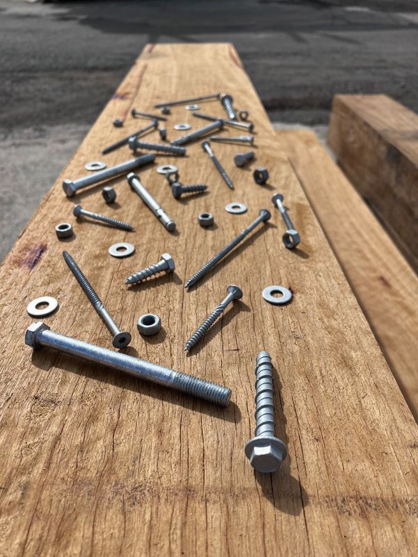 A Bunch of Screws and Nuts Are on a Wooden Table — B & B Timbers Ballina In West Ballina, NSW
