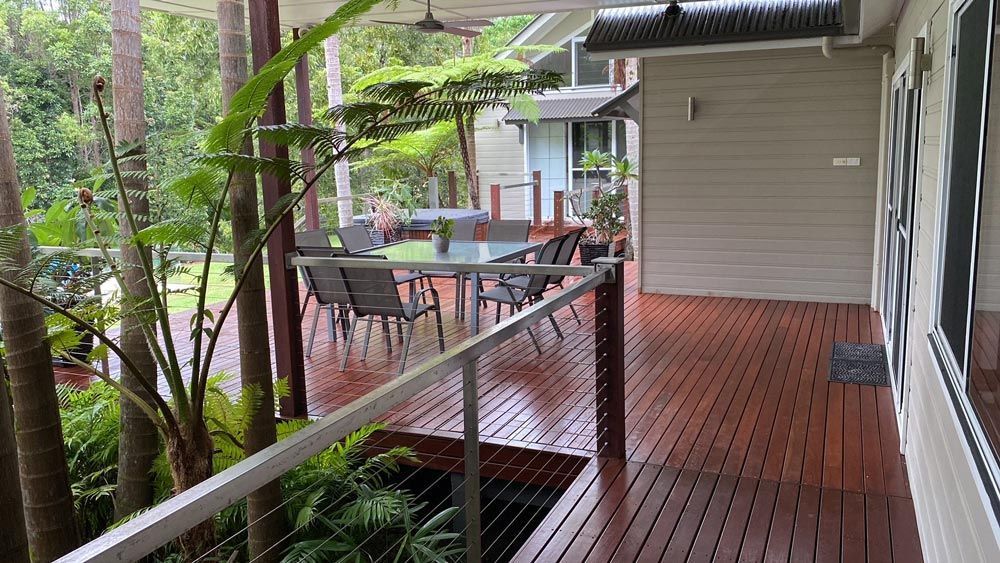 A Wooden Deck With a Table and Chairs on It — B & B Timbers Ballina In West Ballina, NSW