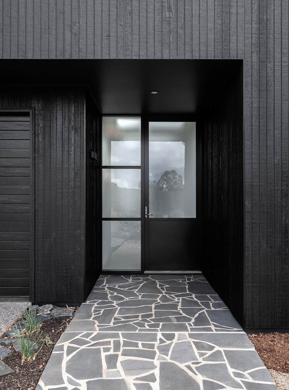 A Black House With a Black Door and a Stone Walkway Leading to It — B & B Timbers Ballina In West Ballina, NSW