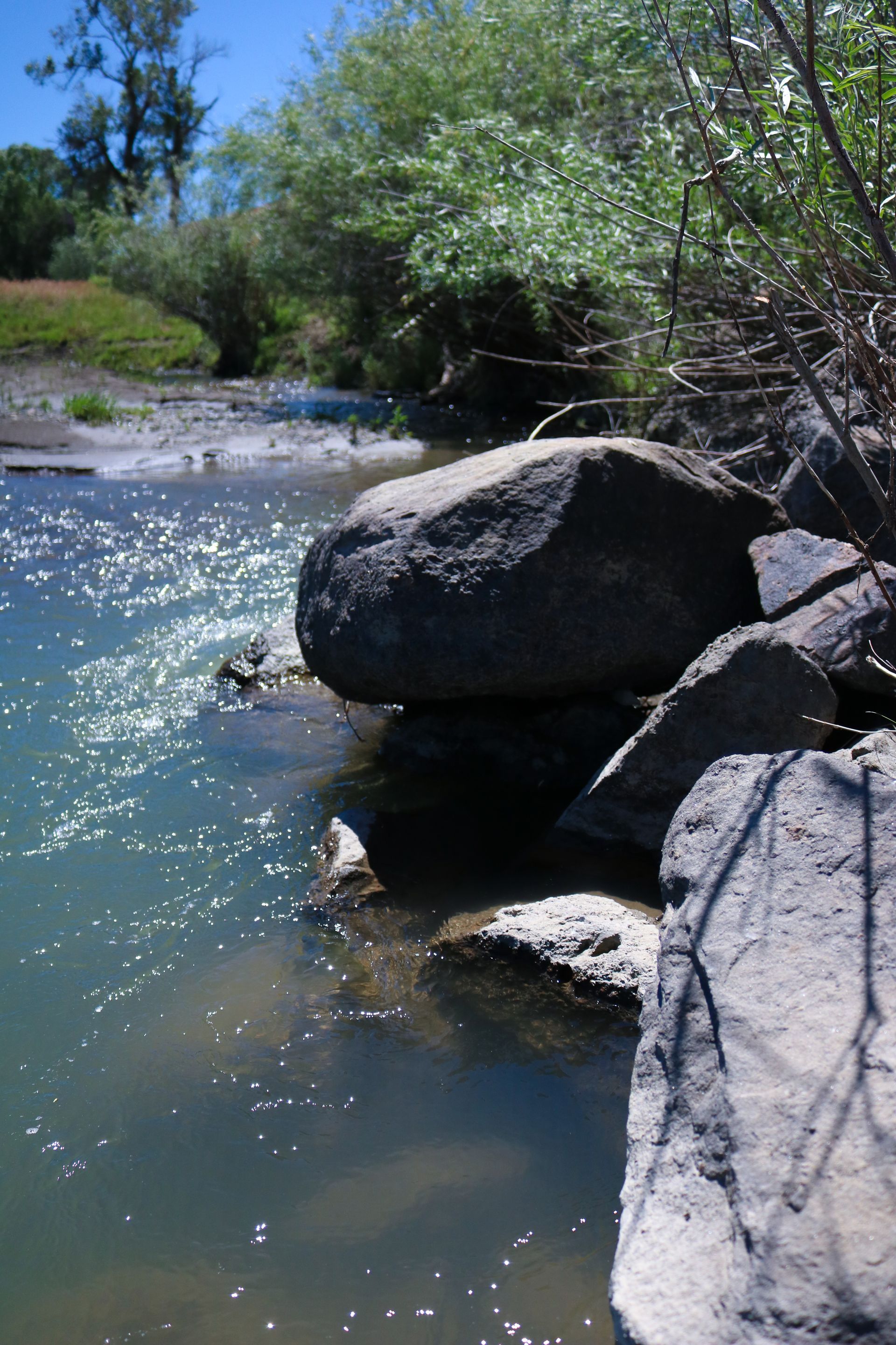 A river with a large rock in the middle of it