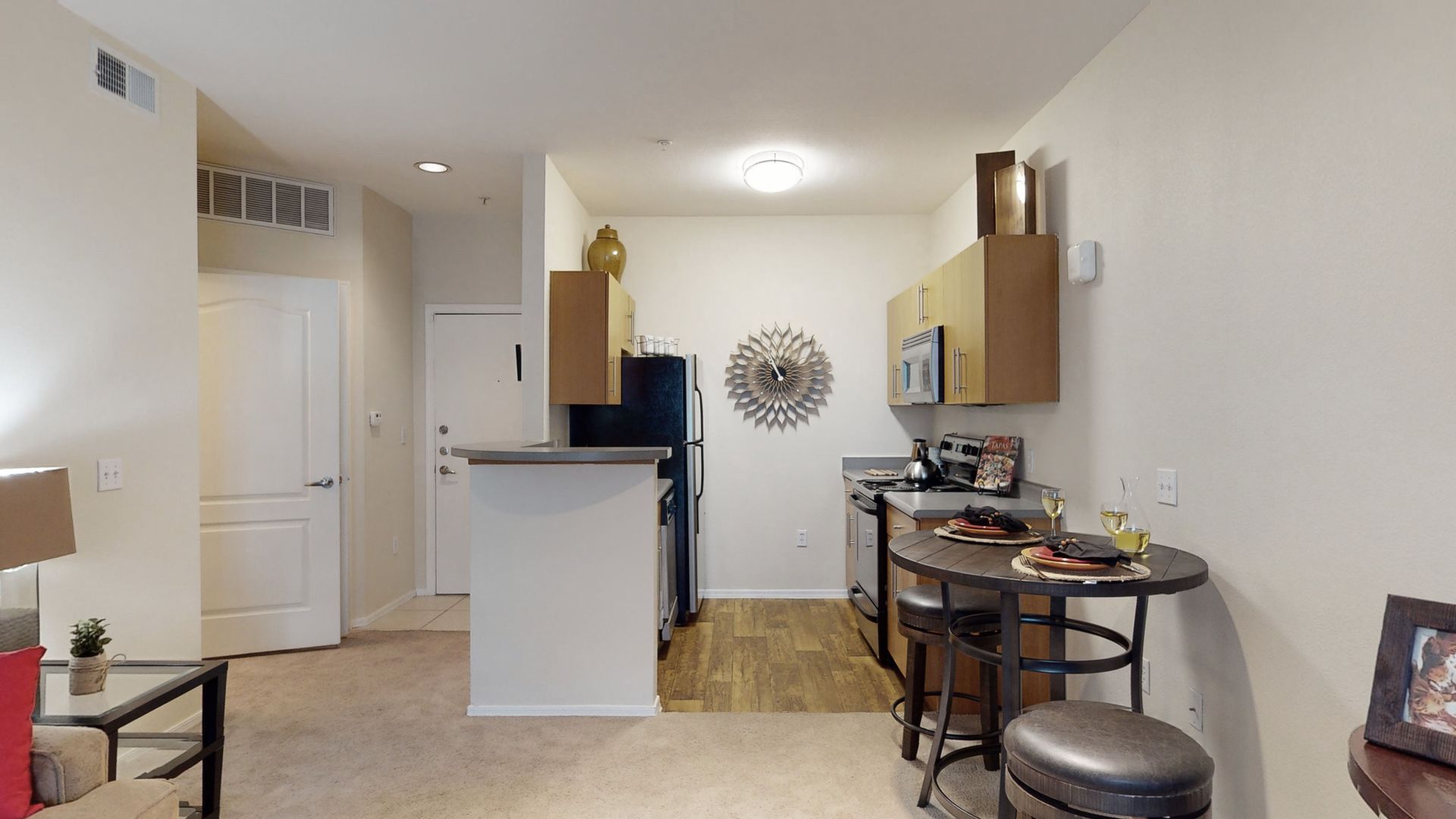 A 3d model of a kitchen and living room in a apartment.
