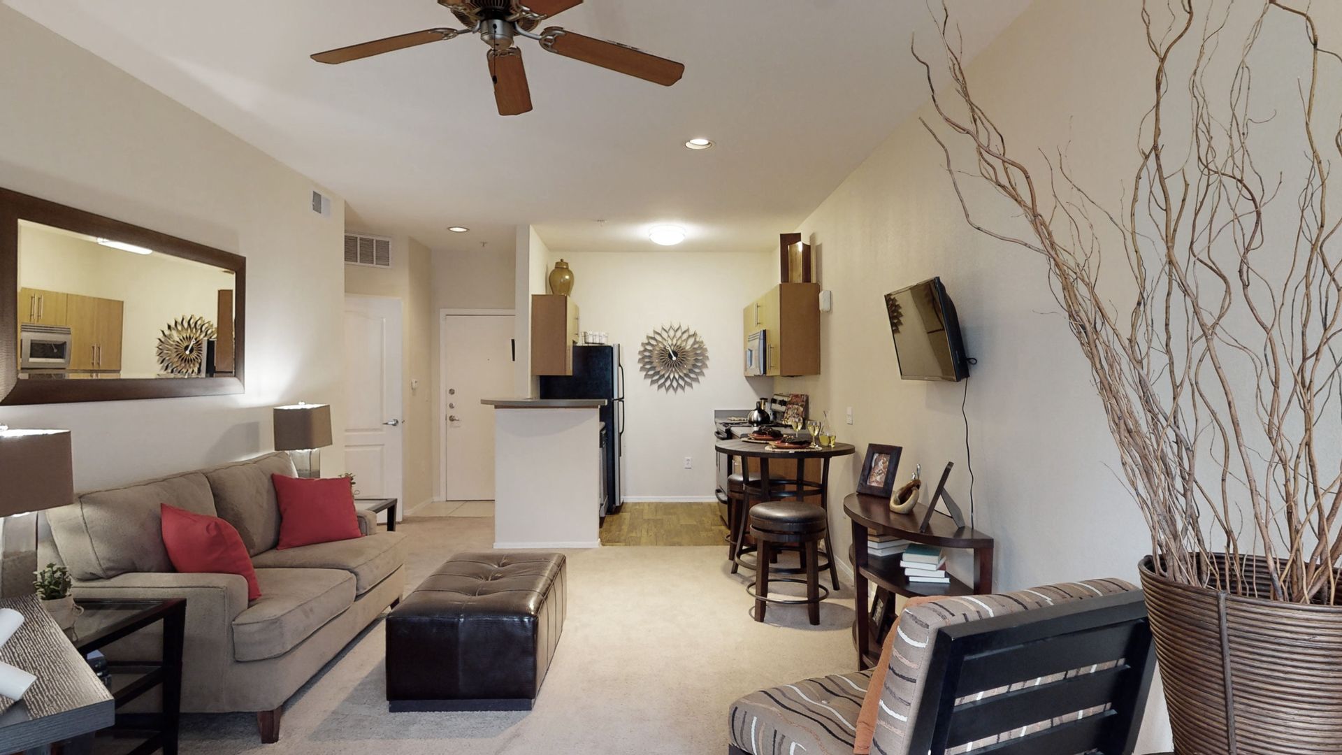A living room with a ceiling fan and a couch
