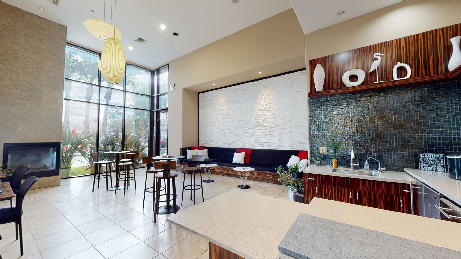 A living room with tables and chairs and a fireplace.