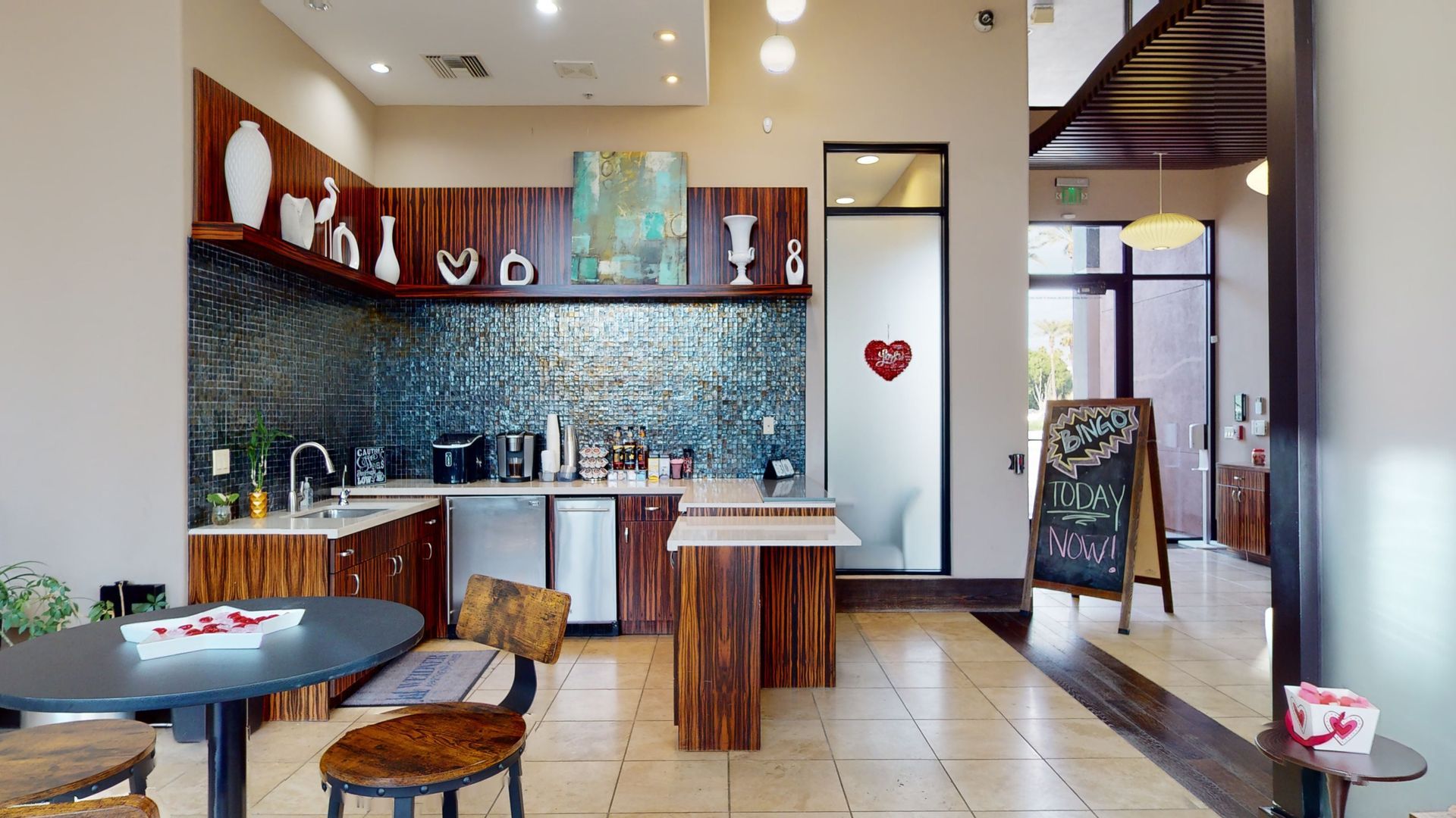 A kitchen with a table and chairs in it
